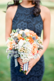 Blue hydrangreas, orange dahlias, and grey berries. Photography by Brklyn View Photography